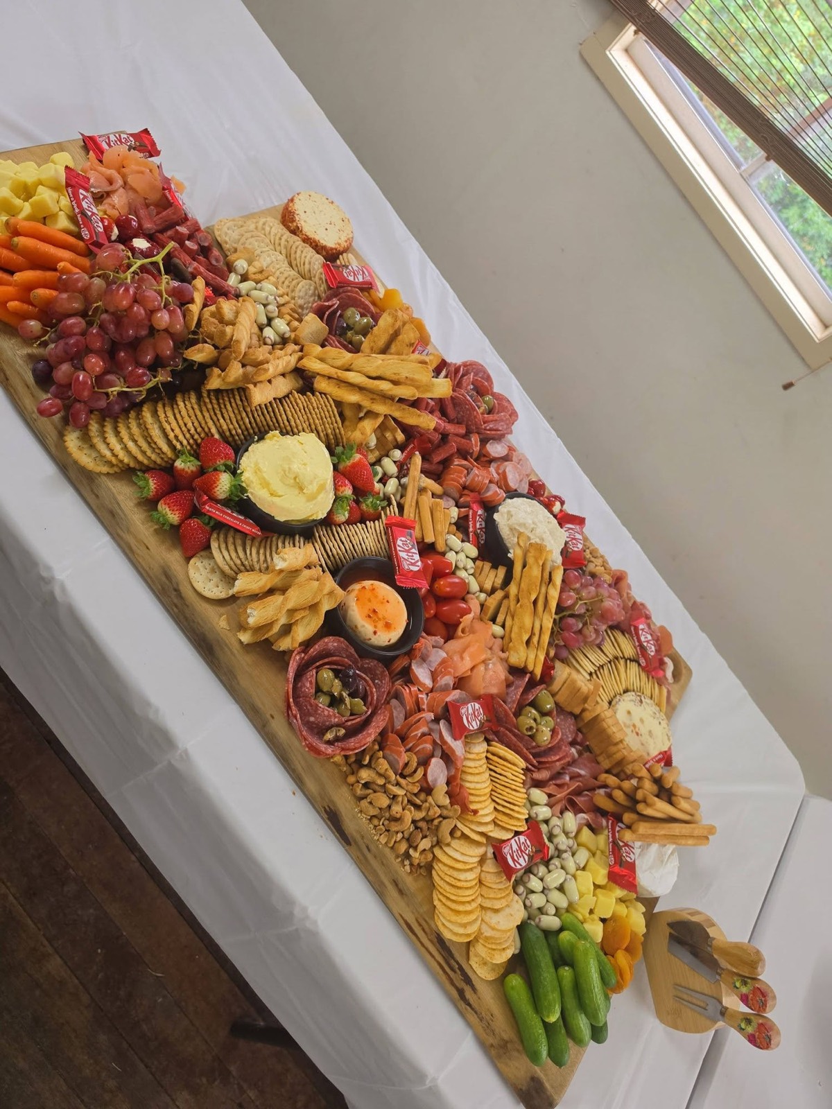A large Zeebras grazing table laden with charcuterie, cheeses, fruit and sweets