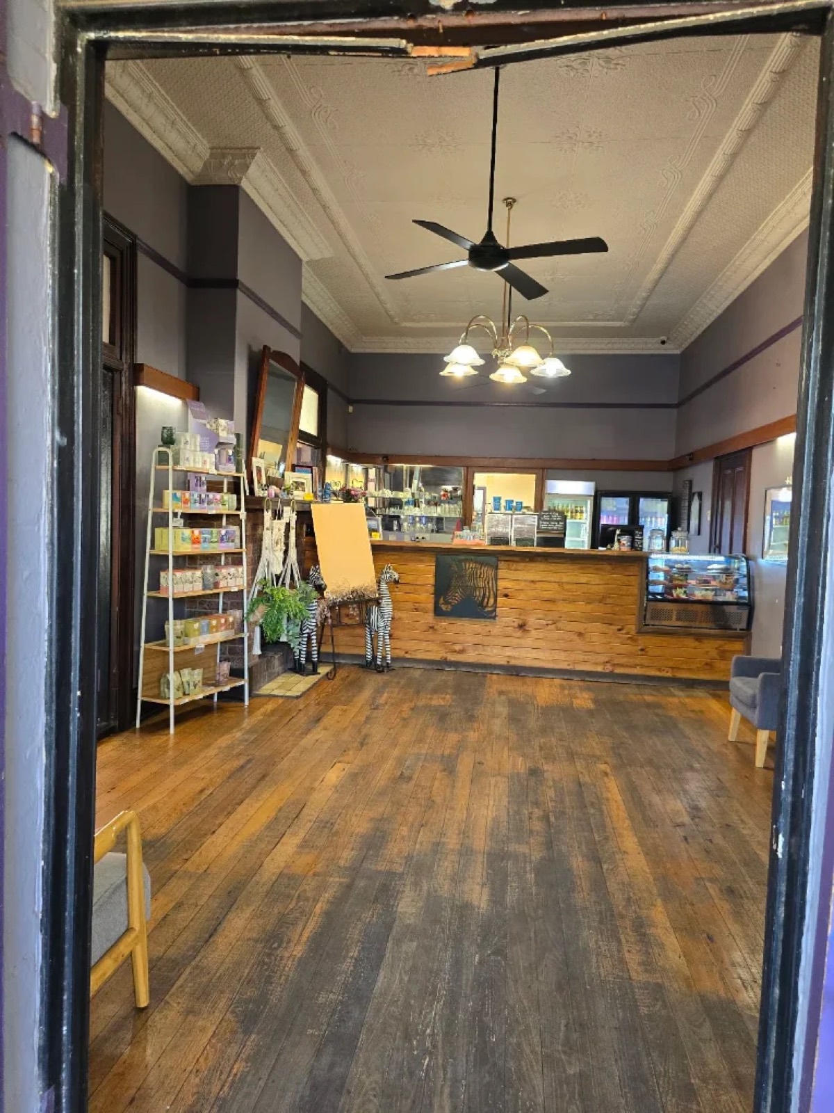 Inside Zeebras: a timber counter, zebra decor and a pressed-tin ceiling